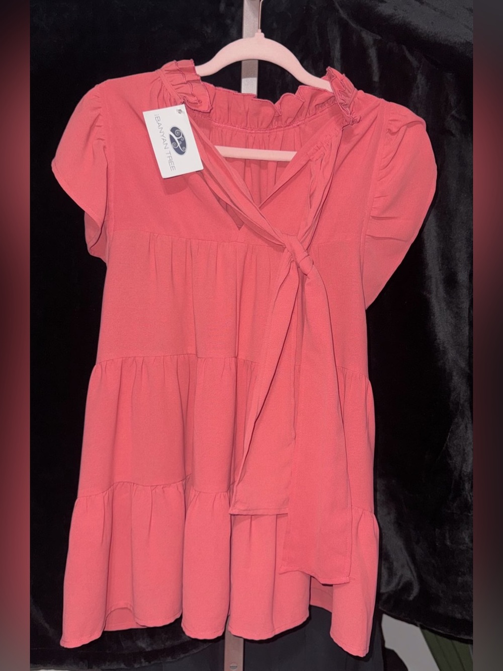 coral tiered dress from Banyan Tree stands out with its charming front-tie